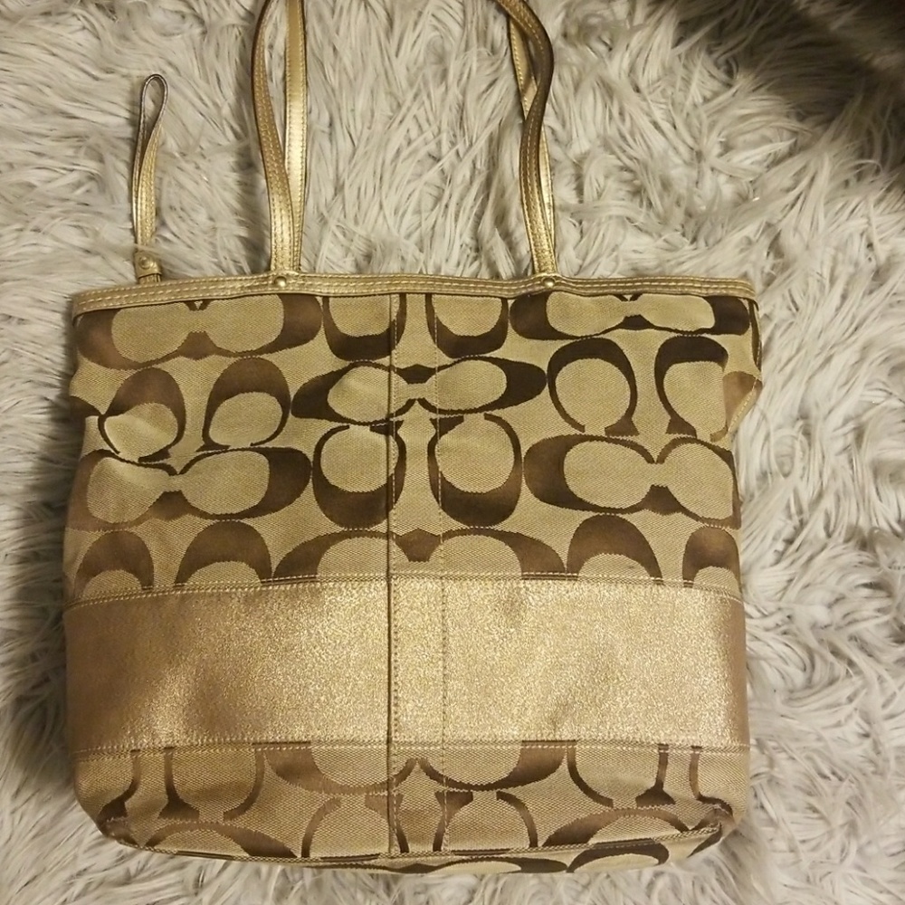 Coach gold purse.A couple visible stains